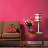 Bright pink eco paint colour Pink Kiss lifestyle image of a hallway, brown sofa and lamp